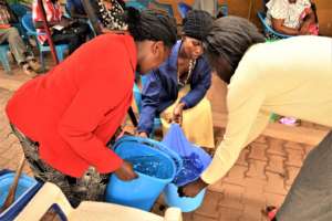 Clients and staff demonstrating water purification