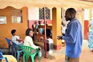 Alex giving clients a water sanitation health talk