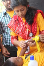 Bandaging an injured street child