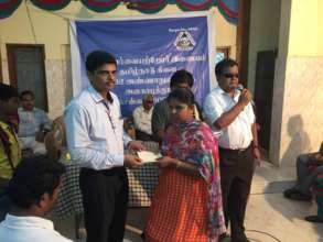 Mr. Soy giving education aid to students