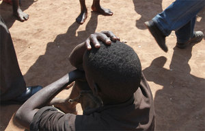 A boy with the head in his hands, Gitega Prison, Burundi