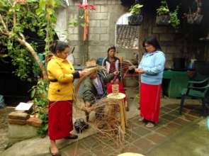 Teaching weaving of worm composting baskets.