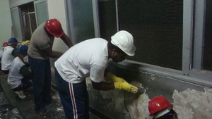 Masonry practical course. Scraping classroom walls