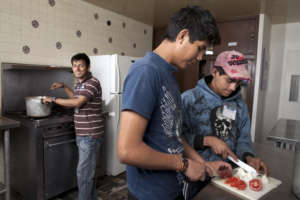 Youth House residents cooking together