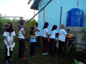 Students lining up to fill wash basins at Sahaya