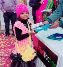 Tuba receiving her packet at launch event