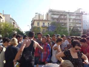 Refugees waiting under the sun to get fresh food