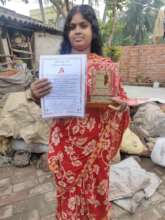Namita proudly showing her farming award