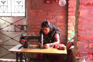 Sabir's wife with her sewing machine