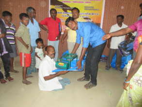 Disabled Person assisted with relief goods