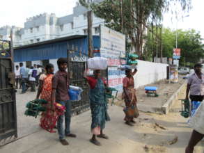 People carrying relief goods to their homes