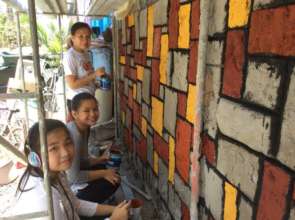 Volunteers painting homes on Mother's Day