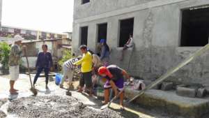 Volunteers and residents build one of 10 new homes