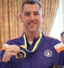 Matt proudly displaying his Boston Marathon medal!