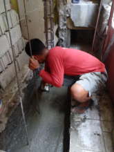 Builder strengthening foundation of house