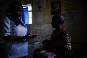 Nurse supporting child with malnutrition in Kenya