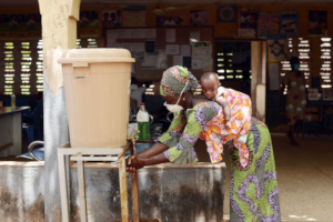 A mother using a hand-washing facility