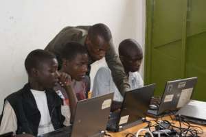 Evode (center) in IT class