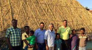 Our team and beneficiaries stand against new roof