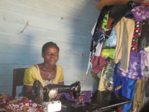 Angeline working in her tailoring shop.