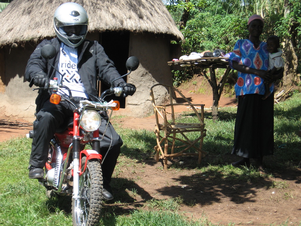 A carer from Vumilia on their motorcycle