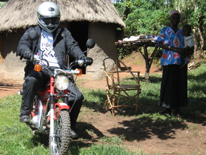 A carer from Vumilia on their motorcycle