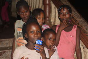Kids outside the orphanage enjoying a fruit drink