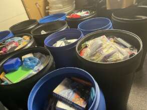 Filling the drums with school supplies to ship out