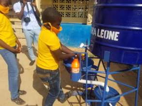 Student using the new hands-free washing station