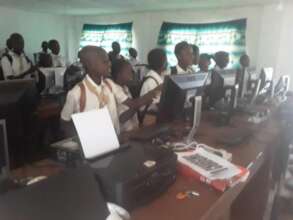 Students excitedly learning first computer class
