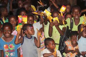 Kids holding pencils in Sierra Leone