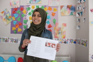 Ragad with her certificate of achievement
