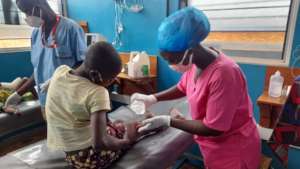 Claudine prepares to remove a surgical drain.