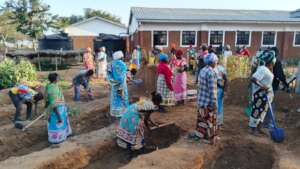 Parents working on a new school kitchen garden