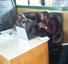 Director Ansou Conde meets with local officials