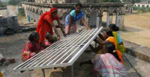 Indian women installing solar panels
