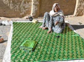 Sadozai making quilts in the sun