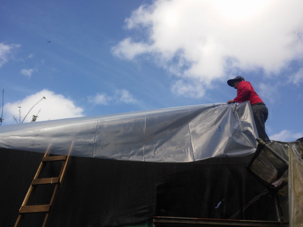 Putting the new plastic on the roof