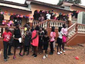 kids in front of repainted dream home