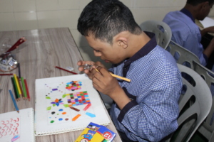 Trainee with intellectual impairment busy drawing