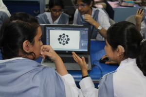 Trainees completing a textile designing assignment
