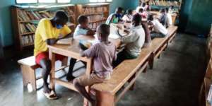 Kids reading books in library