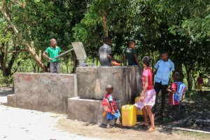 Children from the school playing on the well