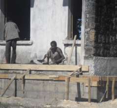The team repairing the floor of the veranda