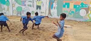 children playing in the sand pit for long jump