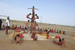 Children practicing Mallakhamb (Gymnastics)