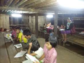 Students studying at night with solar lighting