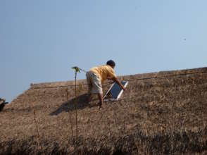 Installing a solar panel at Koung Jor refugee camp