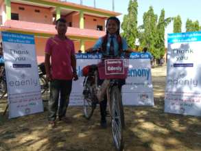 Anjali with her father after receiving the bicycle