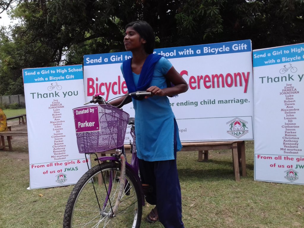 Recipient girl ready to go with the bicycle gift
